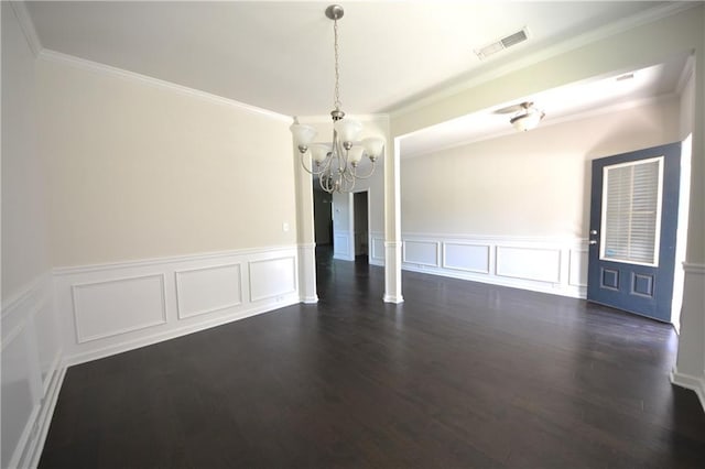 2307 Overlook Ave, Lithonia, GA 30058 - spare room featuring a chandelier, crown molding, a decorative wall, wainscoting, and dark wood-style floors