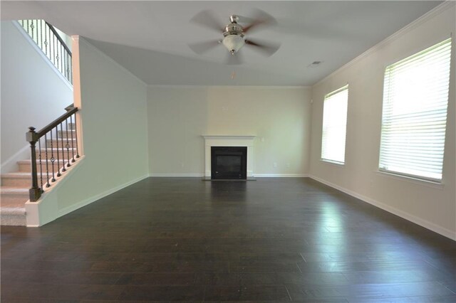 2307 Overlook Ave, Lithonia, GA 30058 - unfurnished living room featuring a ceiling fan, dark wood finished floors, stairs, a glass covered fireplace, and baseboards