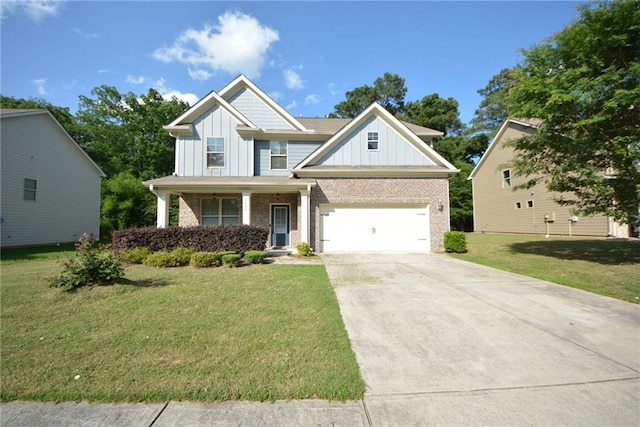 2307 Overlook Ave, Lithonia, GA 30058 - craftsman house featuring board and batten siding, brick siding, concrete driveway, a front lawn, and covered porch