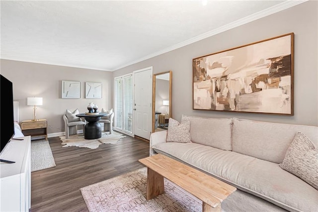 living area with wood finished floors, crown molding, and baseboards