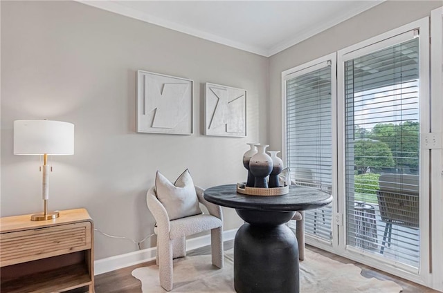 dining room featuring baseboards, crown molding, and wood finished floors