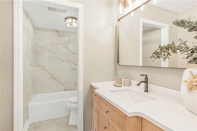 bathroom with toilet, vanity, and tub / shower combination