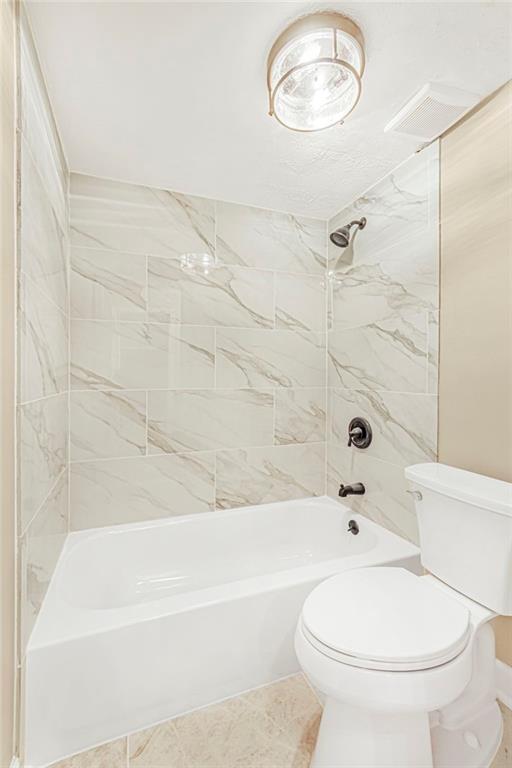 full bath featuring toilet and bathing tub / shower combination