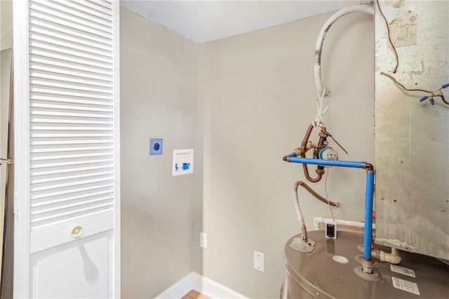 interior space featuring hookup for a washing machine, water heater, baseboards, and hookup for an electric dryer
