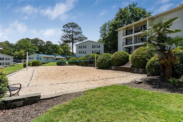 surrounding community featuring volleyball court and a lawn