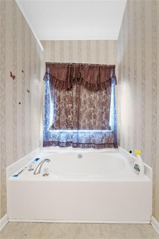 bathroom with tile patterned flooring and a bathtub