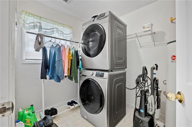 washroom featuring stacked washing maching and dryer