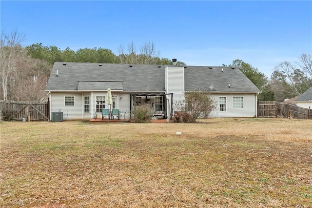 back of house with a deck and a lawn