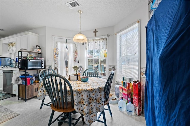 dining area featuring a textured ceiling