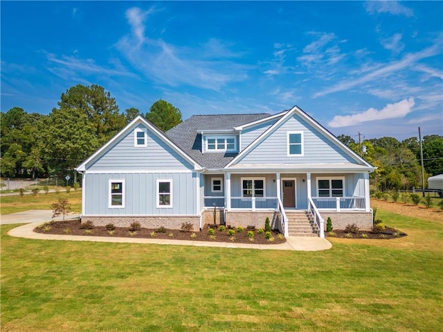 craftsman house with a front yard and a porch