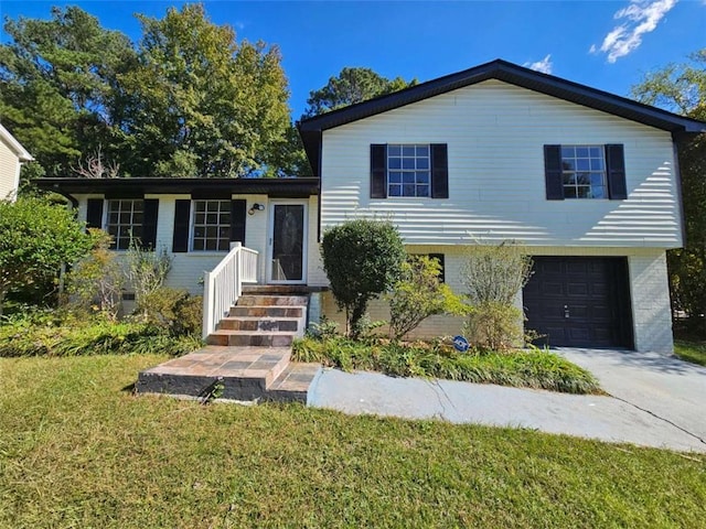 split level home with a garage and a front yard