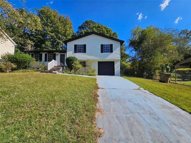 split level home with a front lawn and a garage