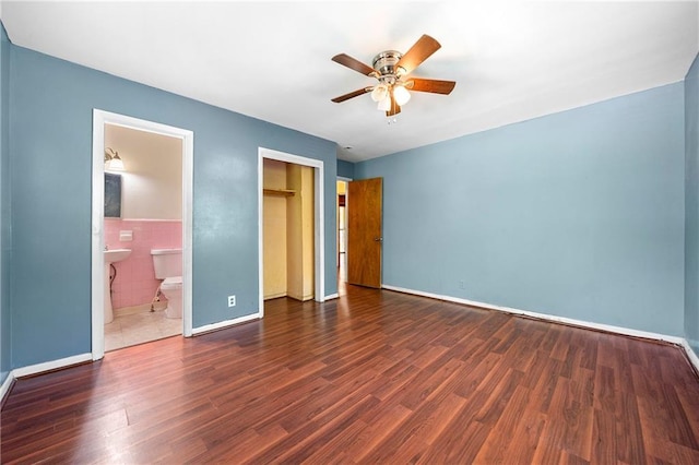 unfurnished bedroom featuring dark hardwood / wood-style floors and tile walls