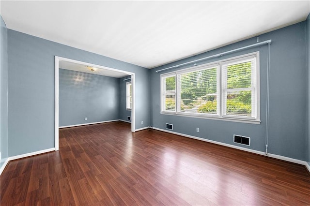 spare room featuring dark hardwood / wood-style flooring