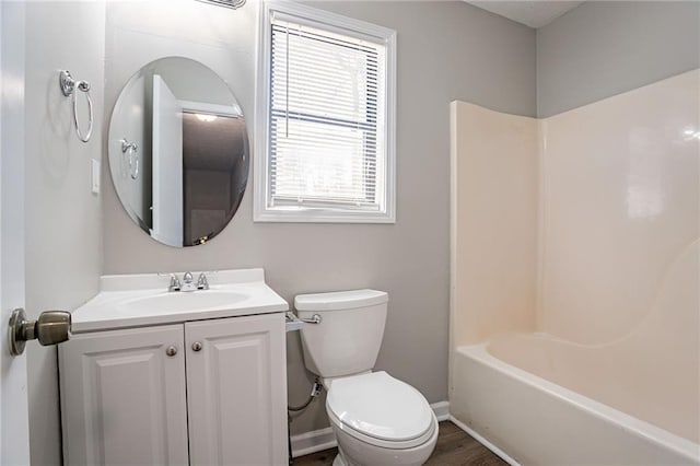 full bath featuring baseboards, toilet, and vanity