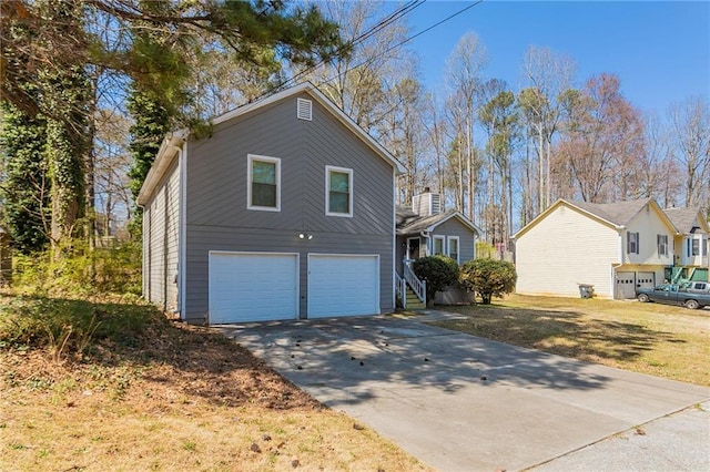 view of home's exterior featuring an attached garage and driveway