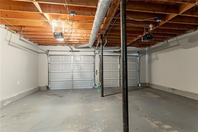 garage featuring a garage door opener and baseboards