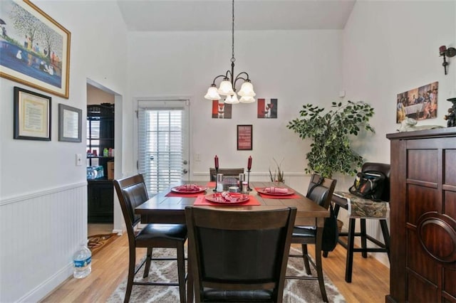 dining room featuring an inviting chandelier and light hardwood / wood-style flooring