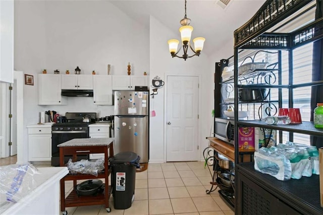 kitchen featuring pendant lighting, appliances with stainless steel finishes, light tile patterned floors, and white cabinets