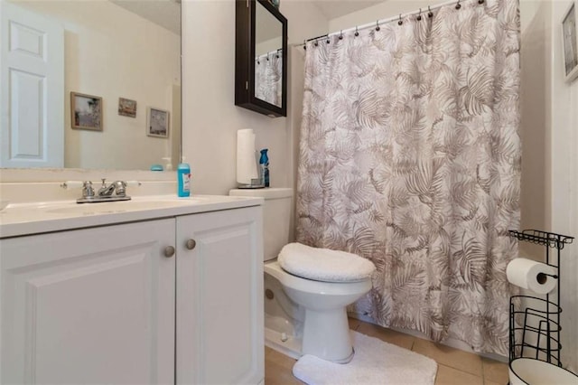 bathroom featuring vanity, tile patterned floors, and toilet