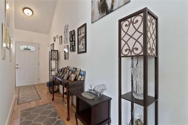 entryway featuring lofted ceiling and light hardwood / wood-style floors