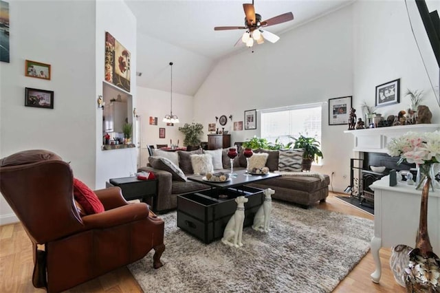 living room with hardwood / wood-style flooring, vaulted ceiling, and ceiling fan