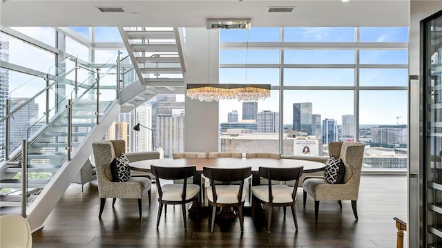 dining room with expansive windows, wood-type flooring, and a chandelier