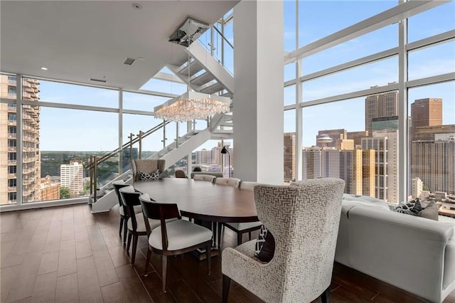 dining space featuring expansive windows, dark hardwood / wood-style floors, and an inviting chandelier