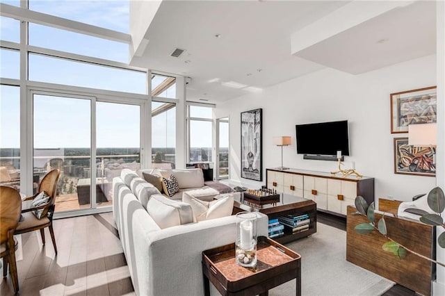 living room with hardwood / wood-style flooring and expansive windows