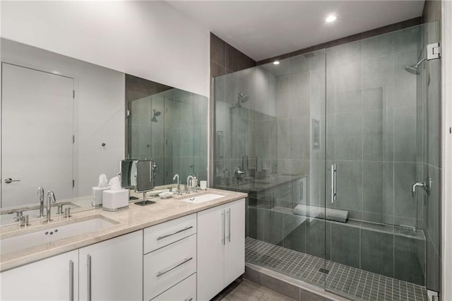 bathroom with vanity and a shower with door