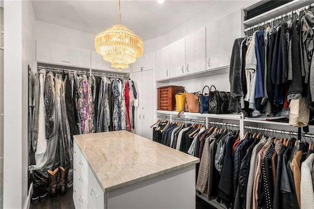 walk in closet featuring a notable chandelier