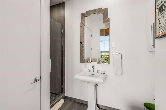 bathroom with tile patterned flooring and a shower with door