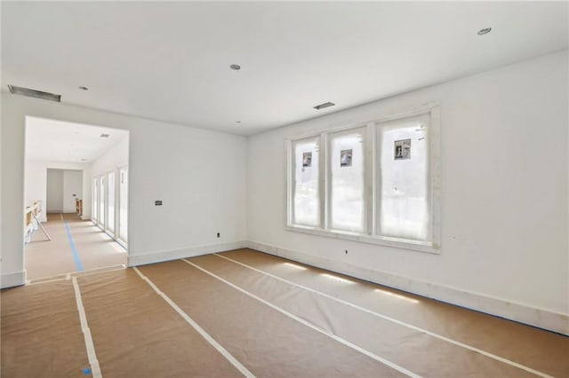 unfurnished living room with baseboards