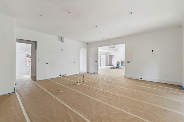 unfurnished living room featuring healthy amount of natural light
