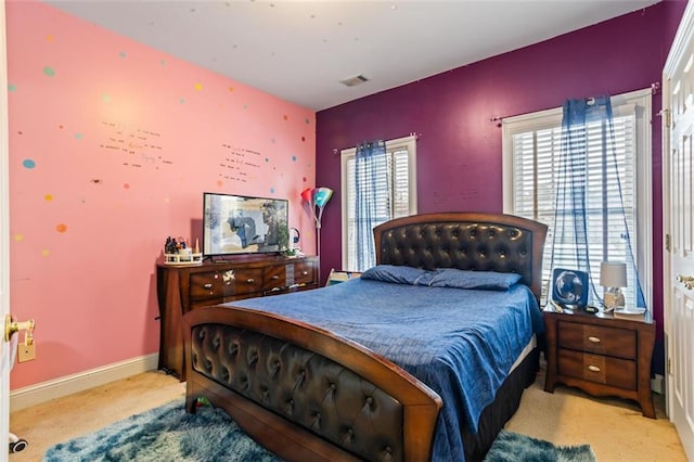 carpeted bedroom with visible vents and baseboards