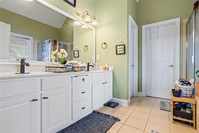 full bath with tile patterned flooring, a shower stall, double vanity, and a sink