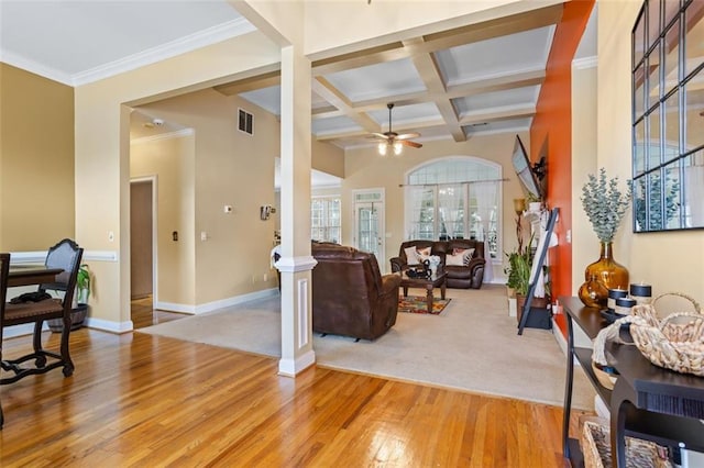 living area with light wood finished floors, visible vents, baseboards, ceiling fan, and coffered ceiling