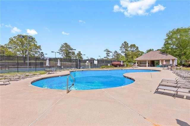 community pool featuring a patio area and fence