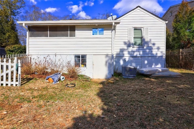 view of property exterior with a yard and central AC unit