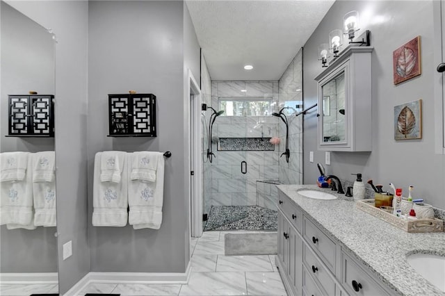 bathroom with vanity, an enclosed shower, and a textured ceiling