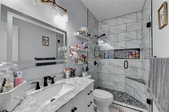 bathroom featuring vanity, an enclosed shower, and toilet