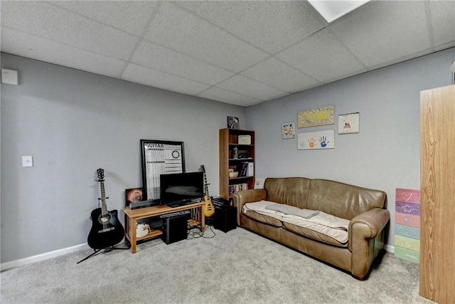 carpeted living room with a drop ceiling