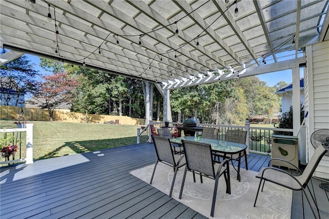 wooden deck with a yard and a pergola