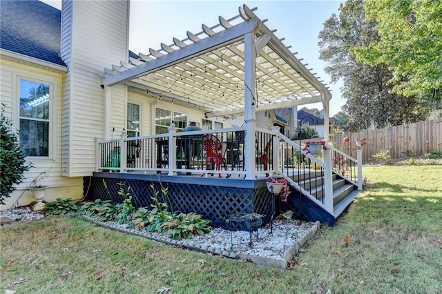 deck featuring a pergola and a lawn