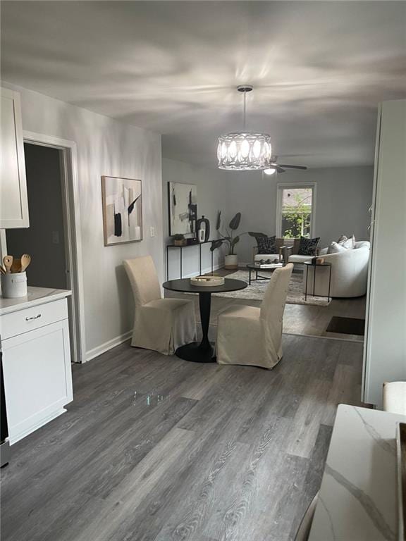 2135 Niskey Lake Rd SW, Atlanta, GA 30331 - dining space featuring baseboards, dark wood finished floors, and ceiling fan with notable chandelier