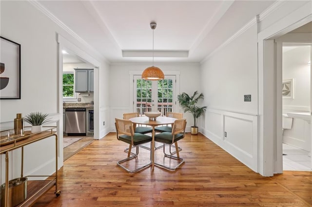 1592 Braeburn Dr SE, Atlanta, GA 30316 - dining area with healthy amount of natural light, light wood finished floors, a raised ceiling, a decorative wall, and french doors