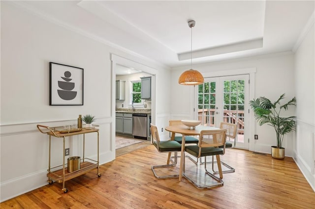 1592 Braeburn Dr SE, Atlanta, GA 30316 - dining room with french doors, light wood finished floors, a tray ceiling, and crown molding