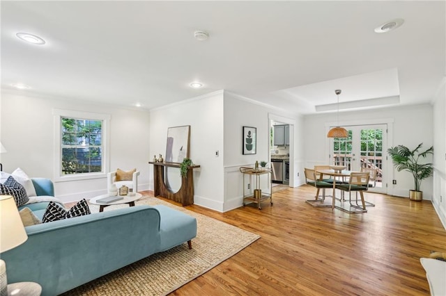 1592 Braeburn Dr SE, Atlanta, GA 30316 - living area featuring light wood-type flooring, a raised ceiling, recessed lighting, ornamental molding, and baseboards