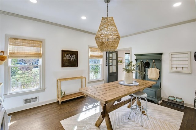 dining room featuring crown molding and dark hardwood / wood-style floors