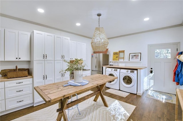 dining space with crown molding, dark hardwood / wood-style floors, and separate washer and dryer